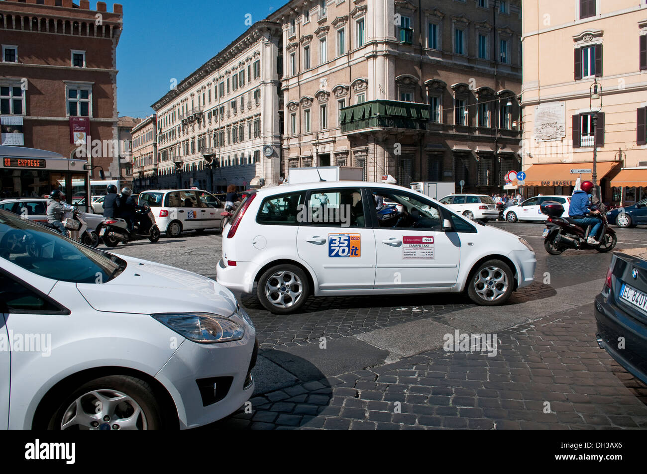 Traffic on Piazza Venezia with official Taxi Car in the centre, Rome, Italy Stock Photo