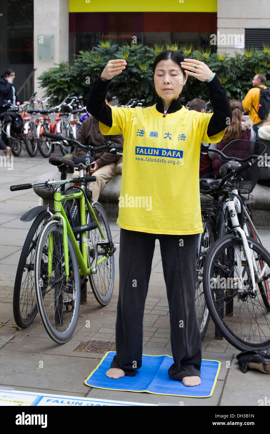 Female Meditating Petitioning against Organ Harvesting Atrocities in China Exposed in China Town London Stock Photo