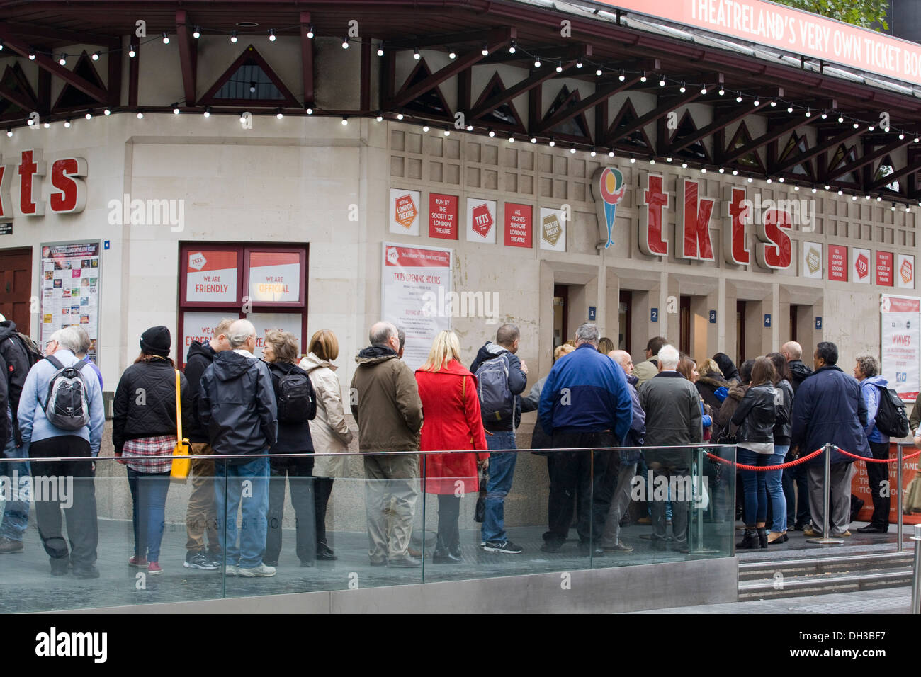 People Queuing in the Rain to Get show Tickets in London's West End Stock Photo