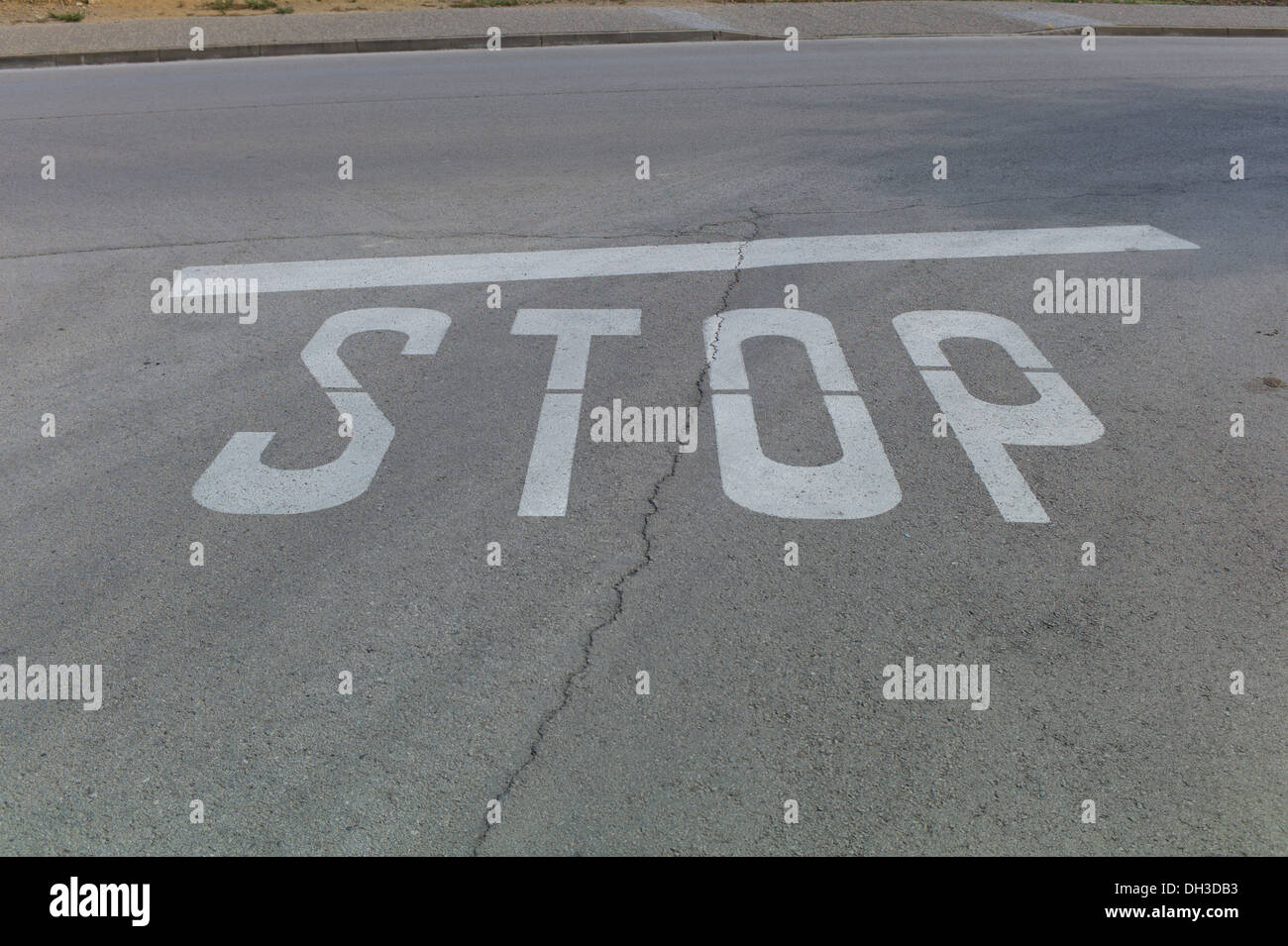 A stop sign painted on the road in Spain Stock Photo