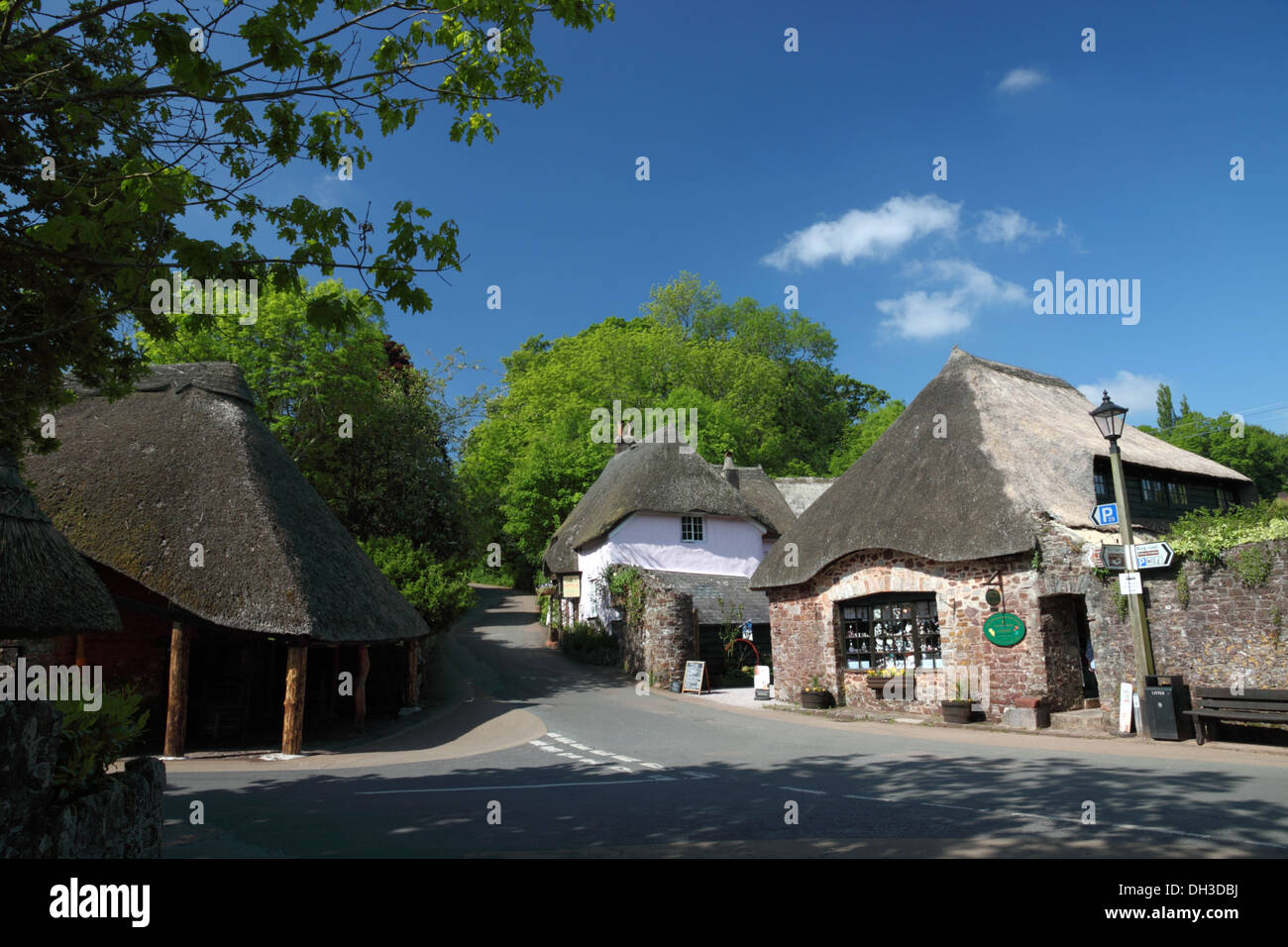 A thatched cottage and shop with blue skies and trees Stock Photo Alamy