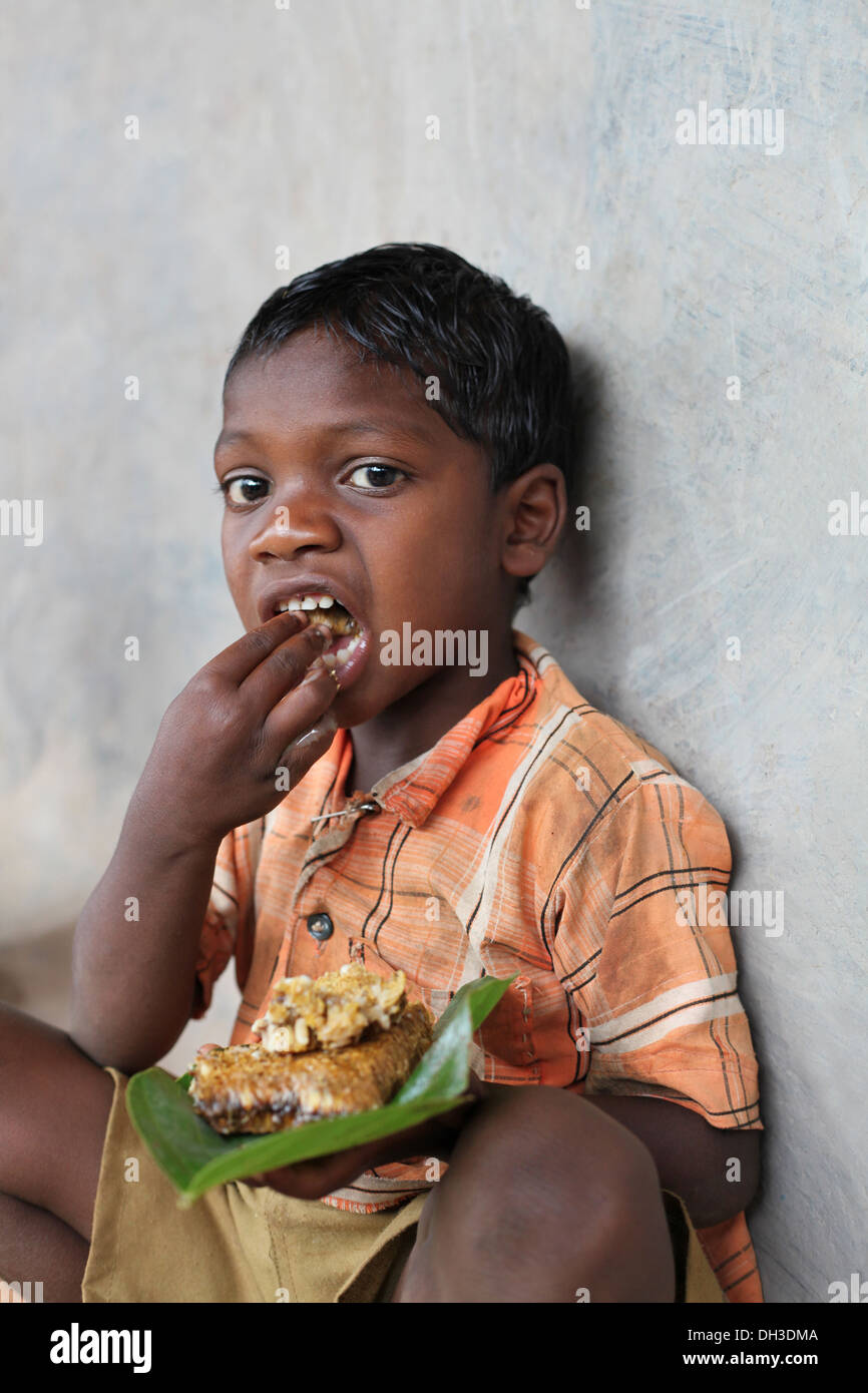 Child eating Chada village, Madhya Pradesh, India Stock