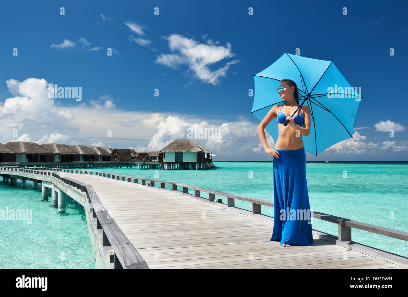 Woman on a beach jetty at Maldives Stock Photo