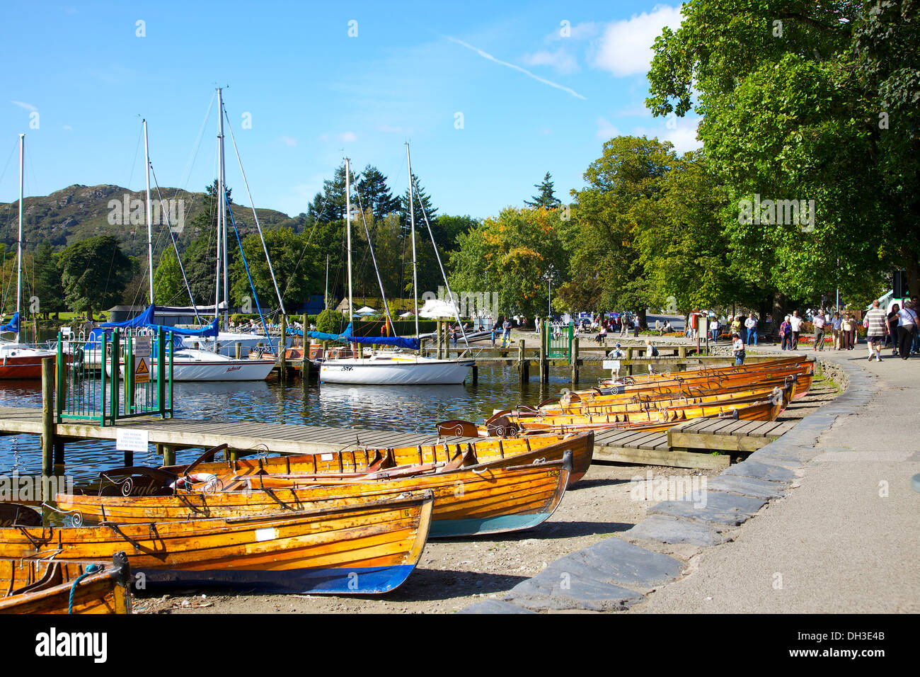 Sailing and rowing boats on Windermere beach at Waterhead Ambleside The