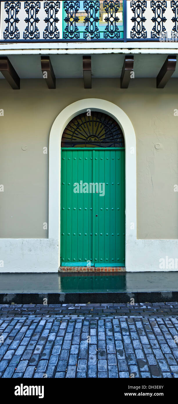 Green doors and cobblestone street, Spanish Colonial facades and cobblestone streets, Old San Juan, Puerto Rico Stock Photo