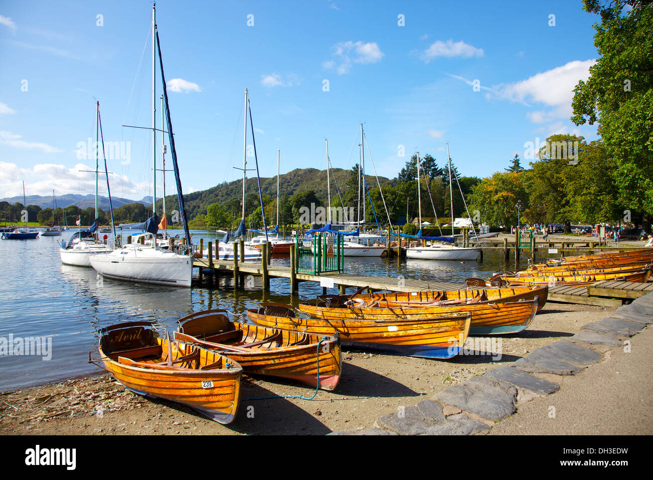 Sailing and rowing boats on Windermere beach at Waterhead Ambleside The