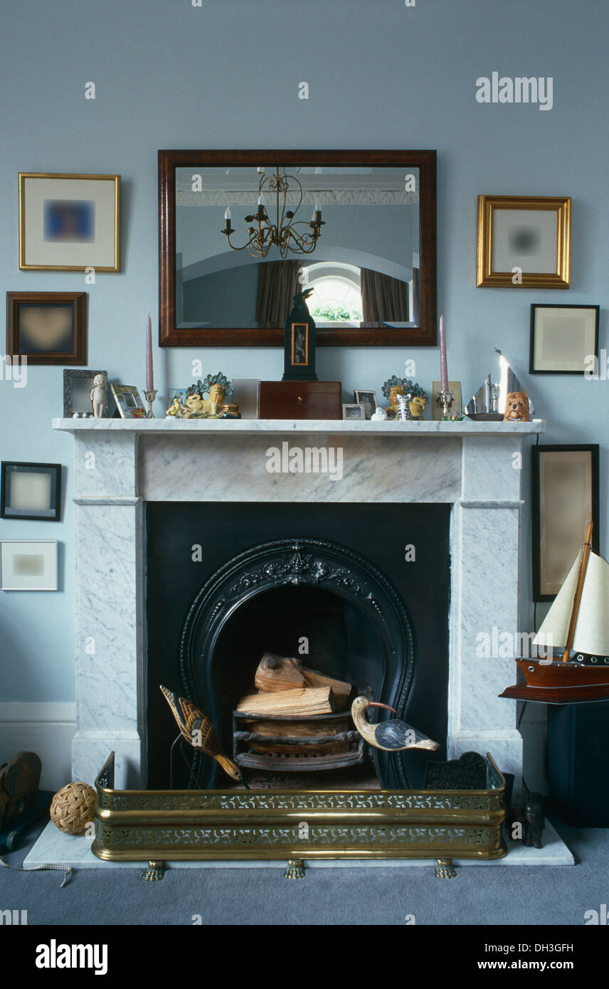 Mahogany Mirror Above Marble Fireplace With Brass Fender In