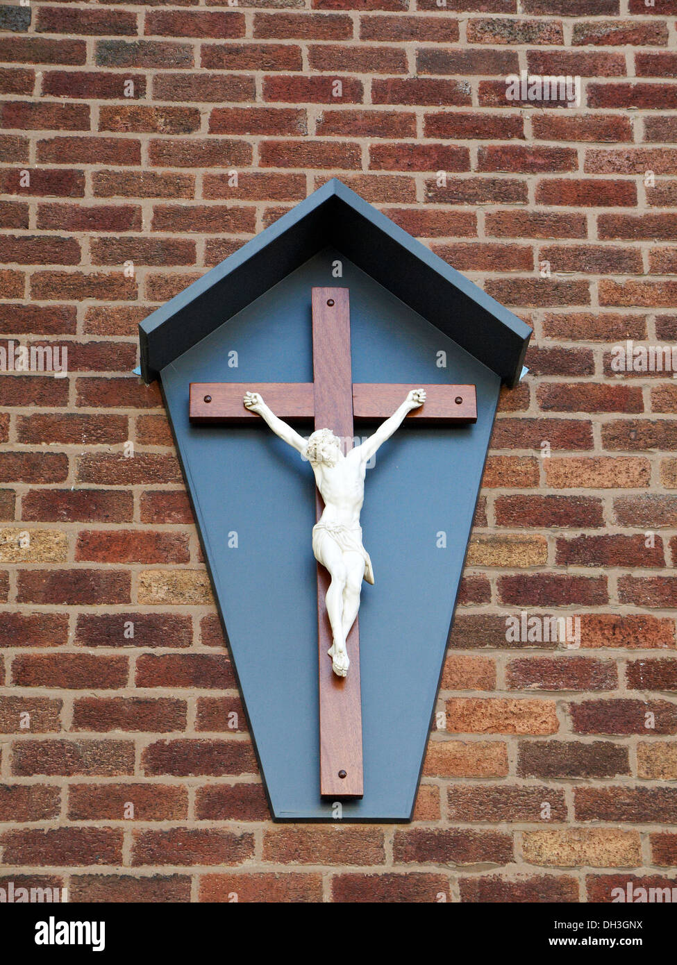 Jesus Christ on cross at outside church wall in Northwich Cheshire UK Stock Photo