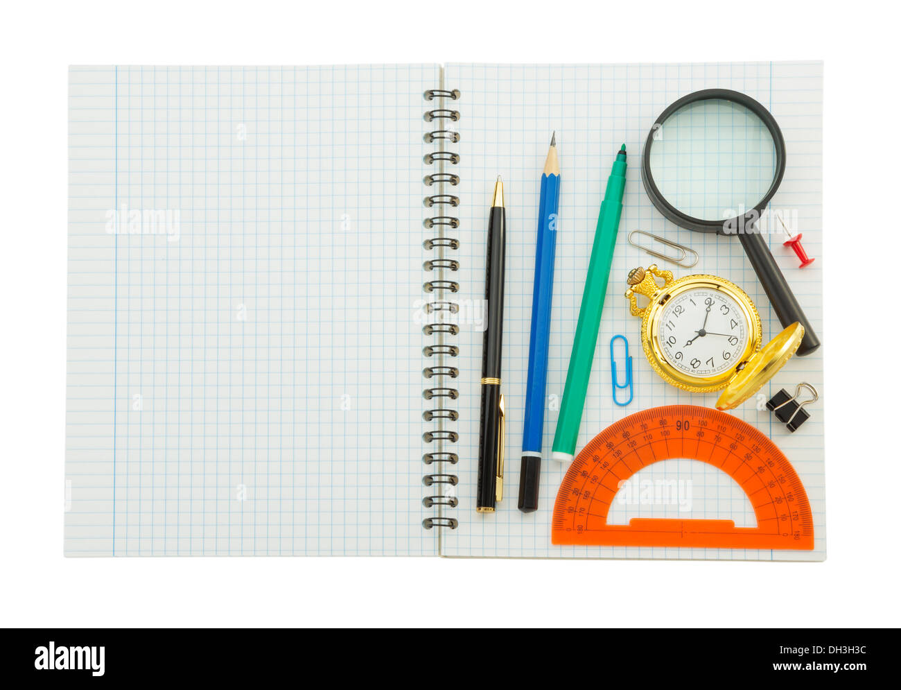 school supplies on checked notebook isolated at white background Stock Photo
