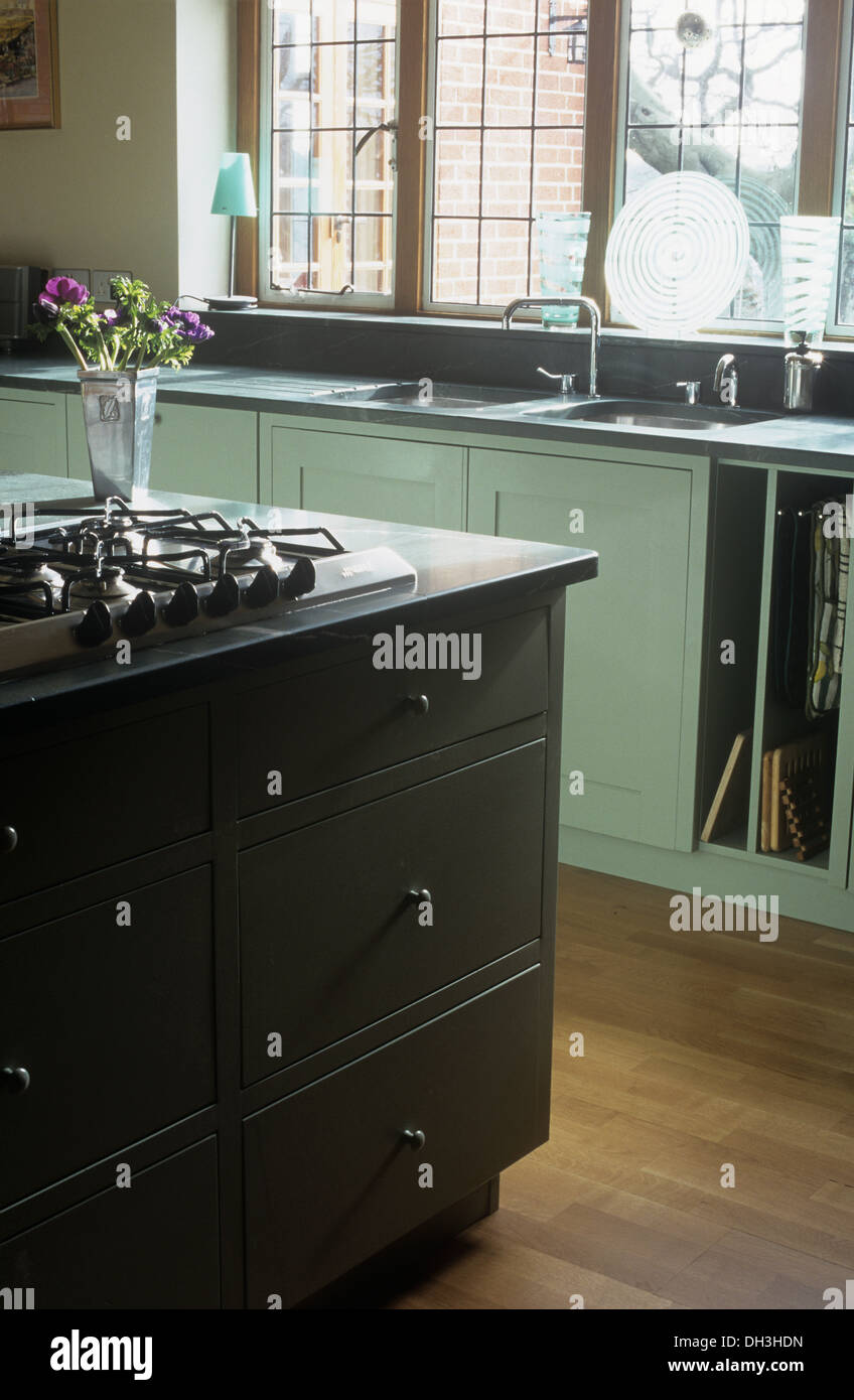 Gas hob in island unit in country kitchen with aqua blue fitted units