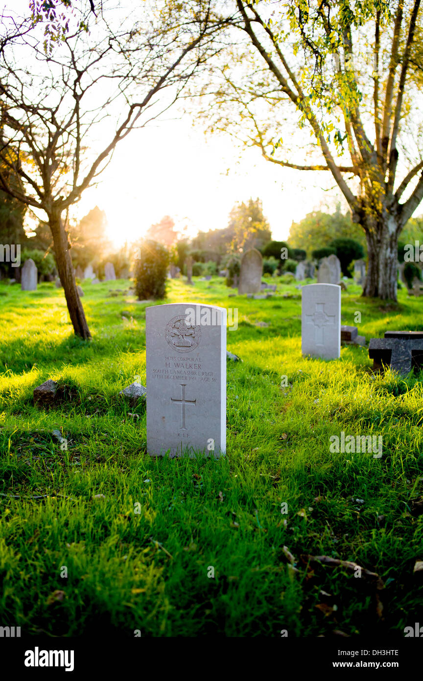 the sun sets over the WW1 graves at old hill lane cemetery Southampton in the foreground is the grave of H Walker Stock Photo