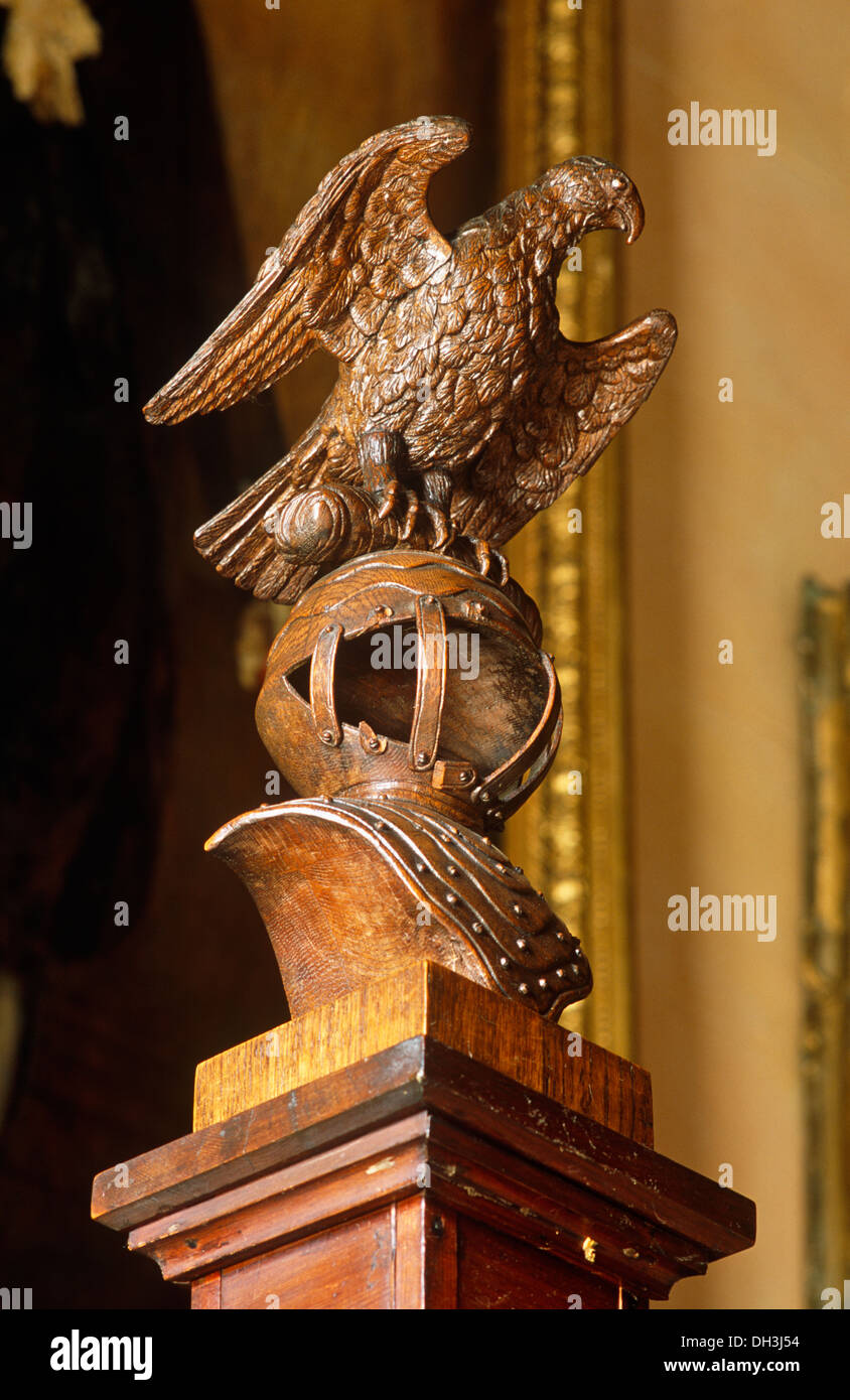 Carved bird figure on newel post of oak staircase Stock Photo