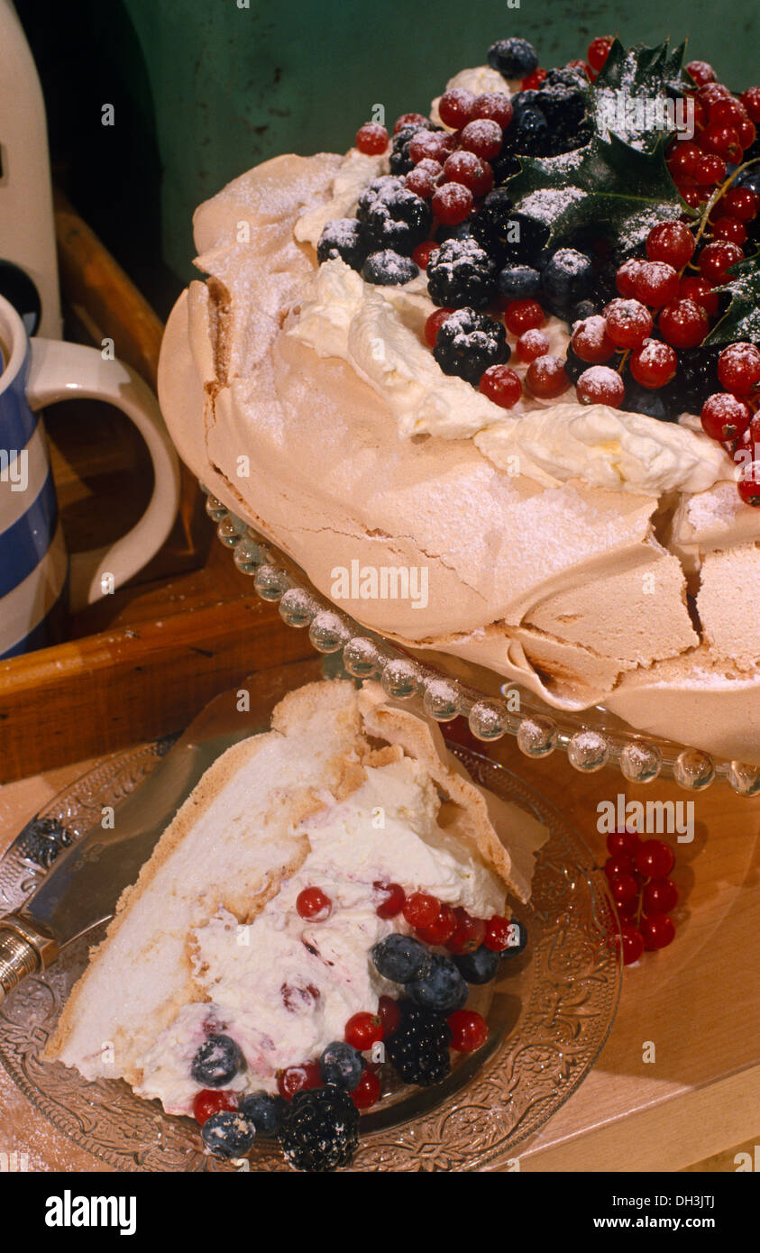 Meringue pavlova topped with red and black currants and black berries Stock Photo