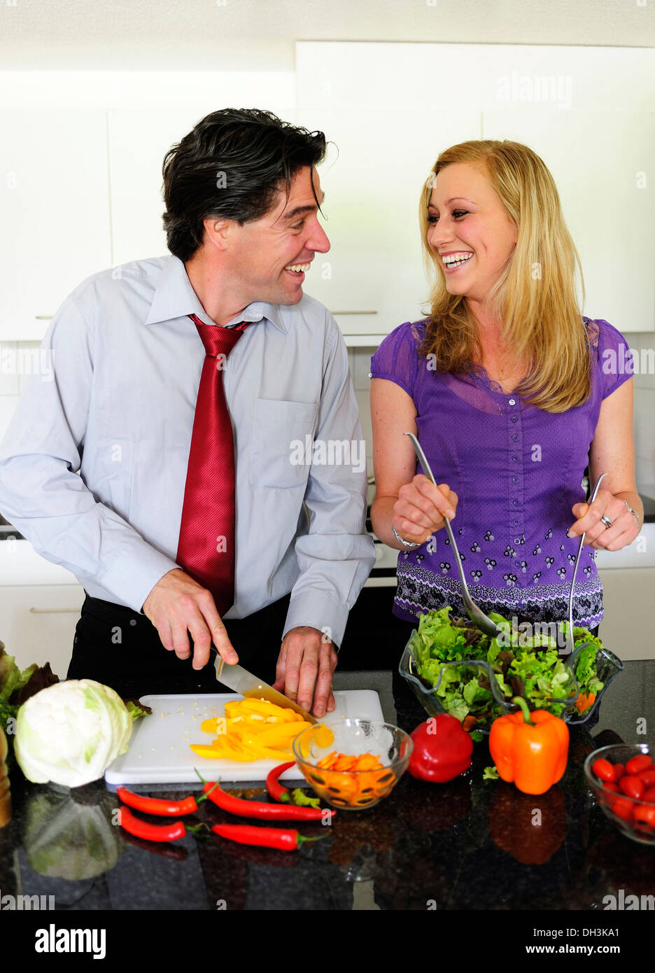 Young couple cutting vegetables for a salad Stock Photo