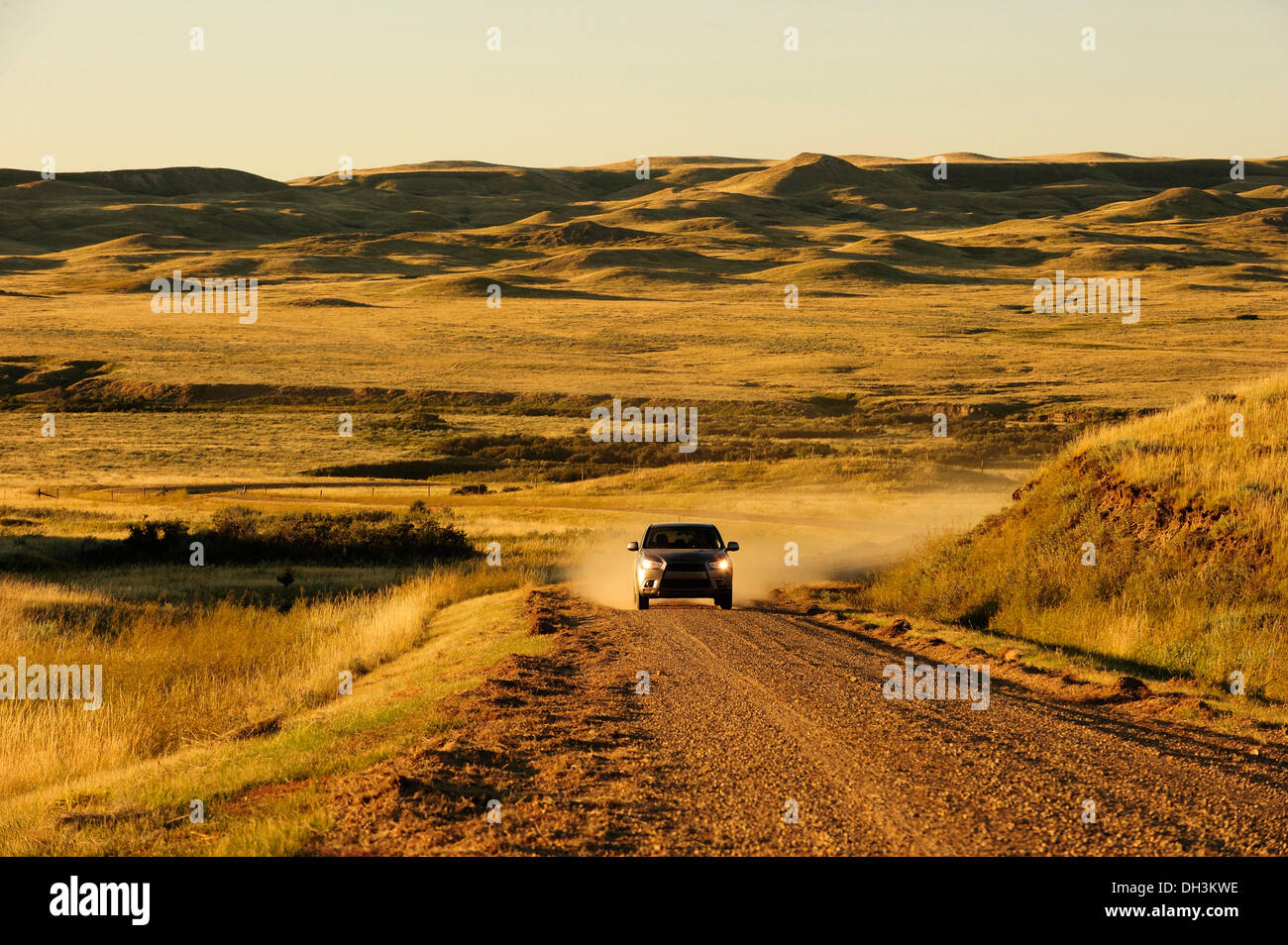 Car on a dirt road on the prairie, Saskatchewan Province, Canada Stock Photo