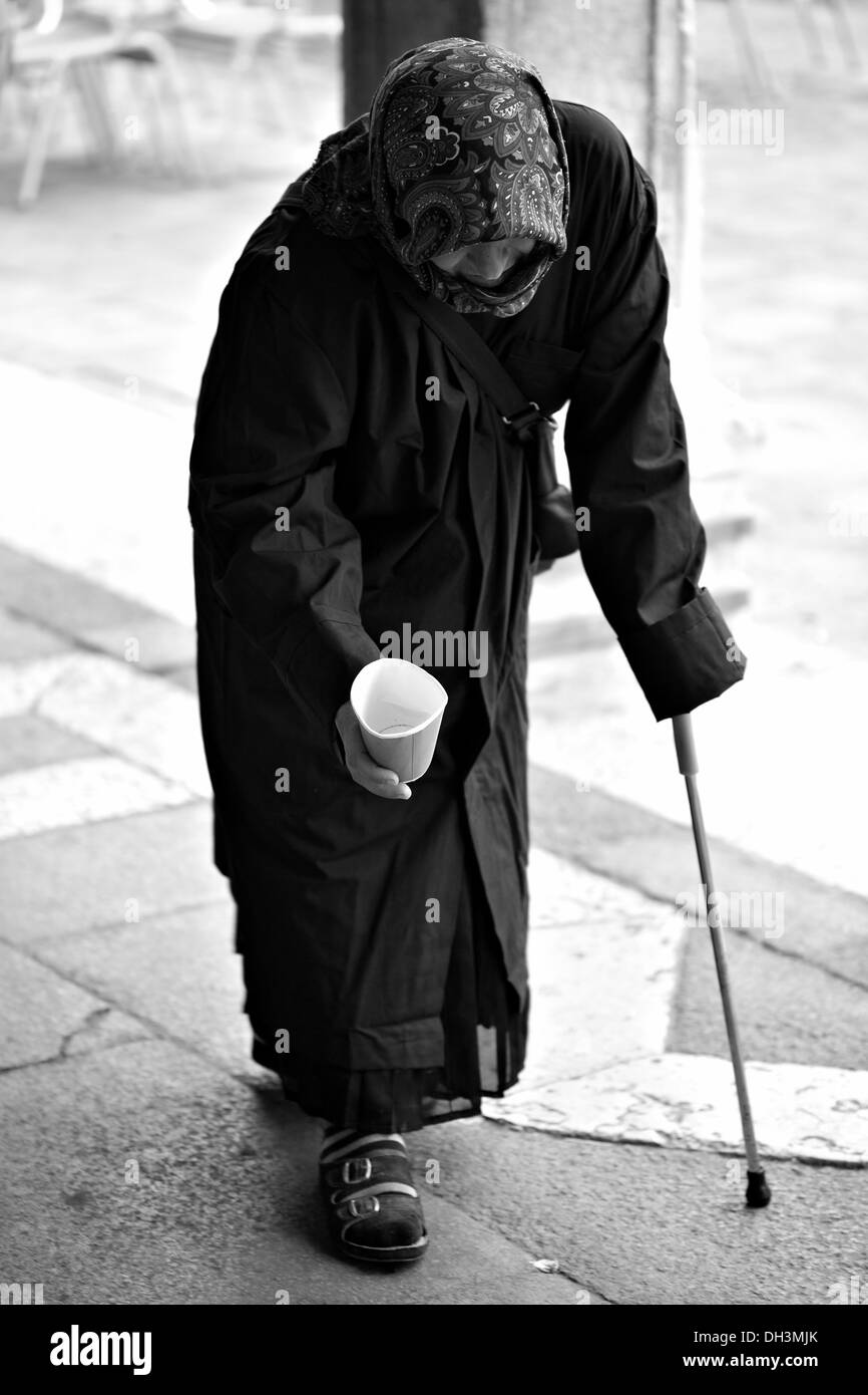 Female beggar with a walking cane, black and white, Venice, Veneto, Italy, Europe Stock Photo