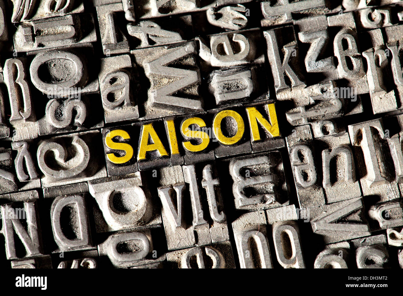 Old lead letters forming the word 'SAISON', German for 'SEASON' Stock Photo