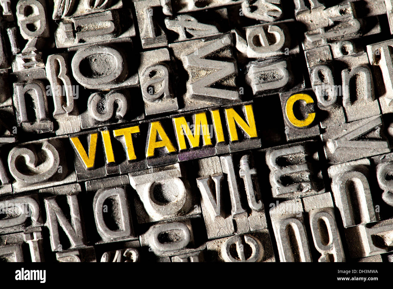 Old lead letters forming the word 'Vitamin C' Stock Photo