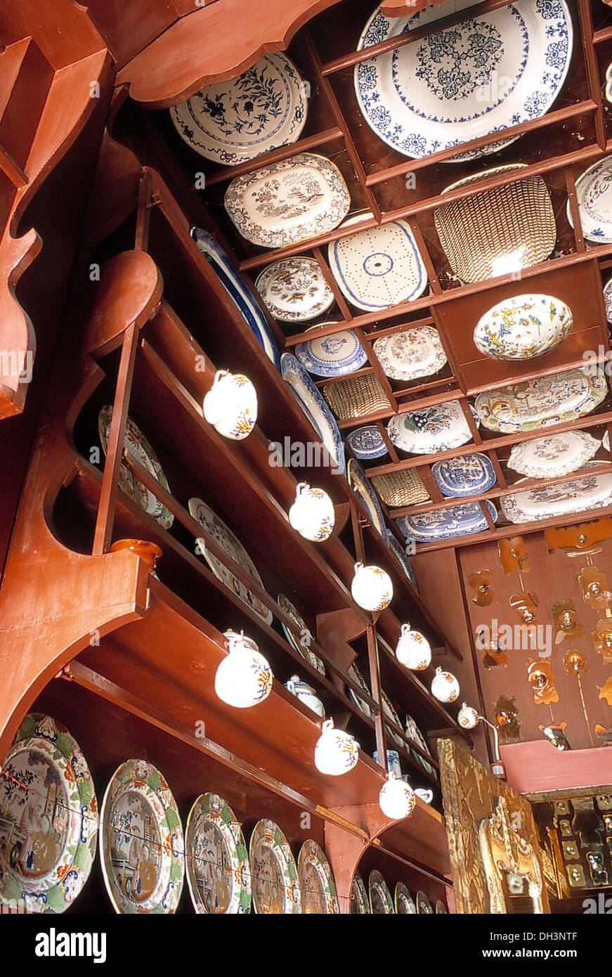 Collection of antique plates and bowls on terracotta wall and ceiling