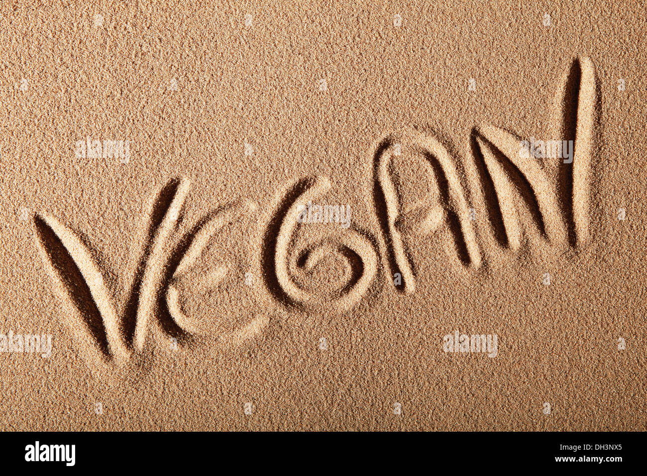 Writing in the sand "VEGAN Stock Photo Alamy