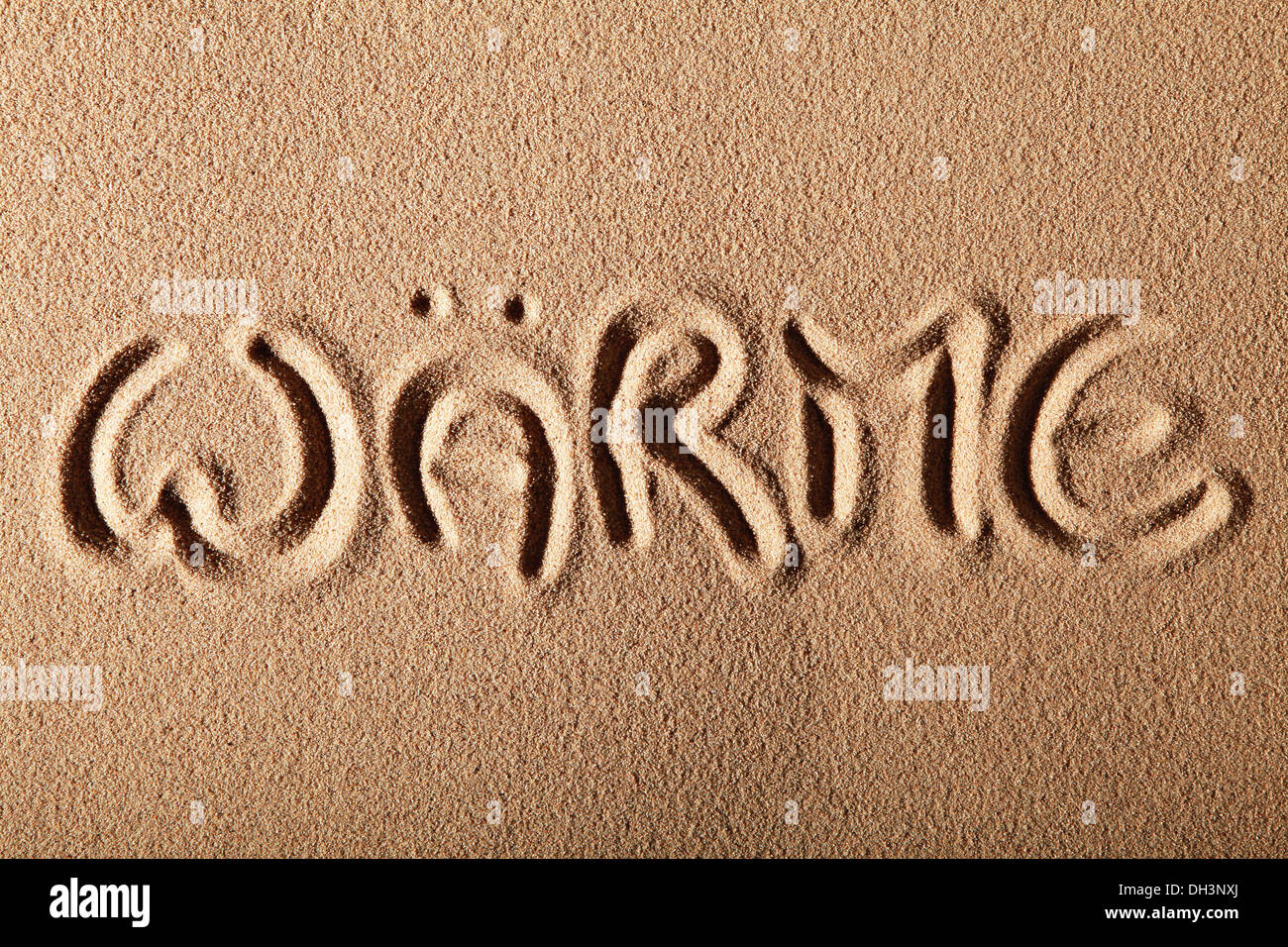 Writing in the sand 'WÄRME' or 'HEAT' Stock Photo