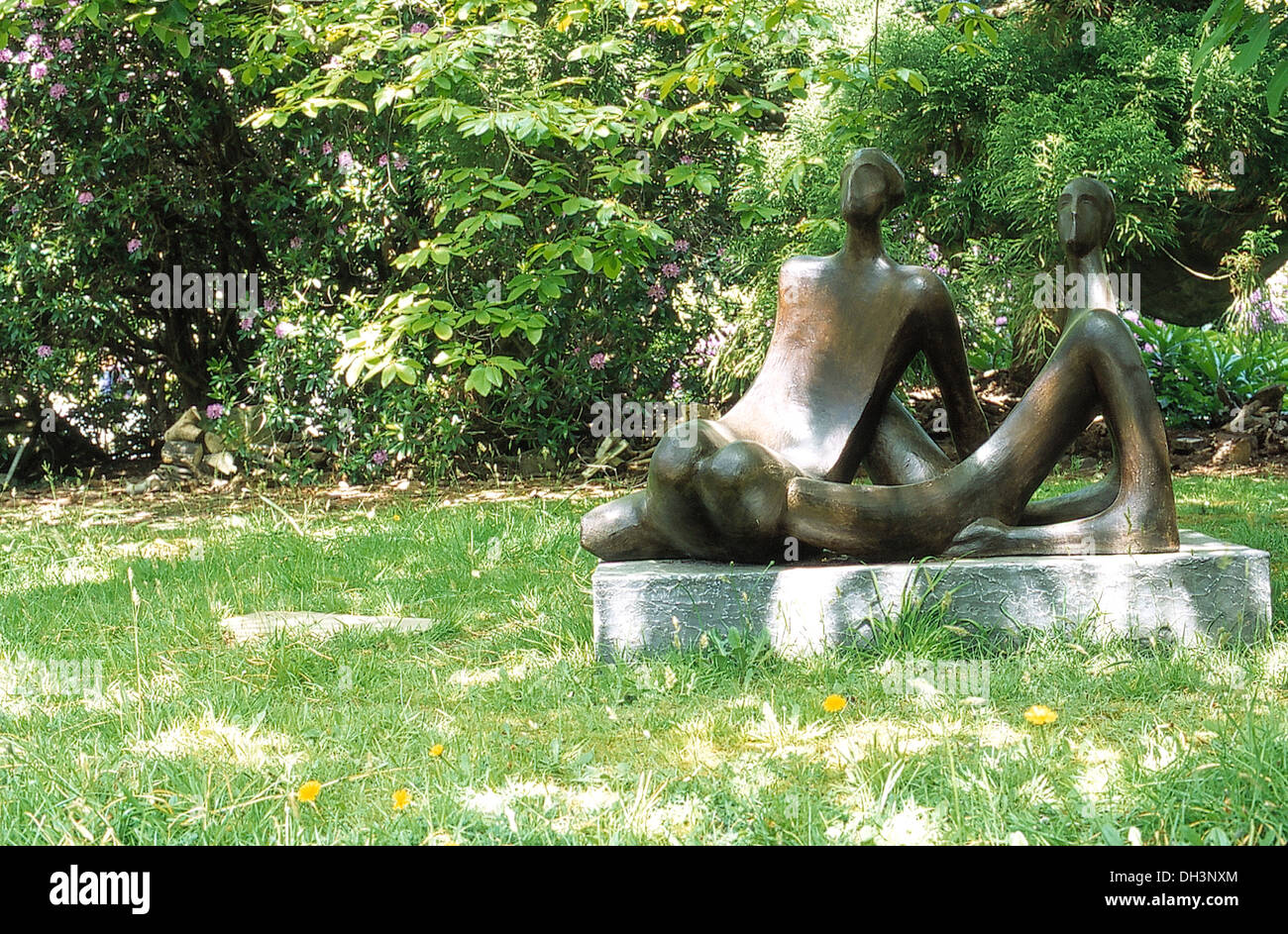 Modern bronze sculptures of the human form in country garden Stock Photo