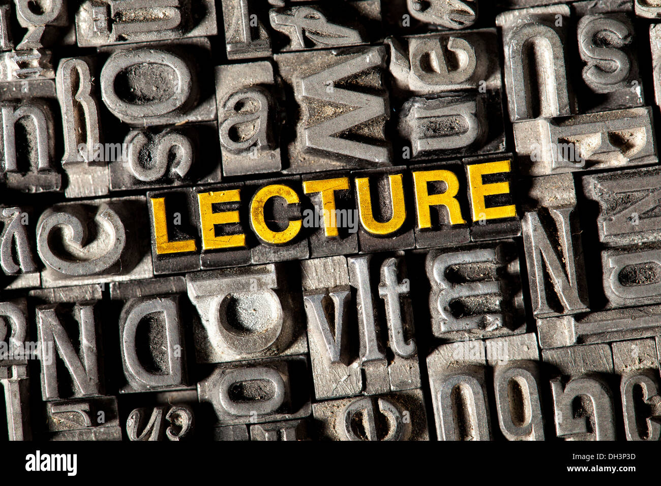 Old lead letters forming the word 'LECTURE' Stock Photo