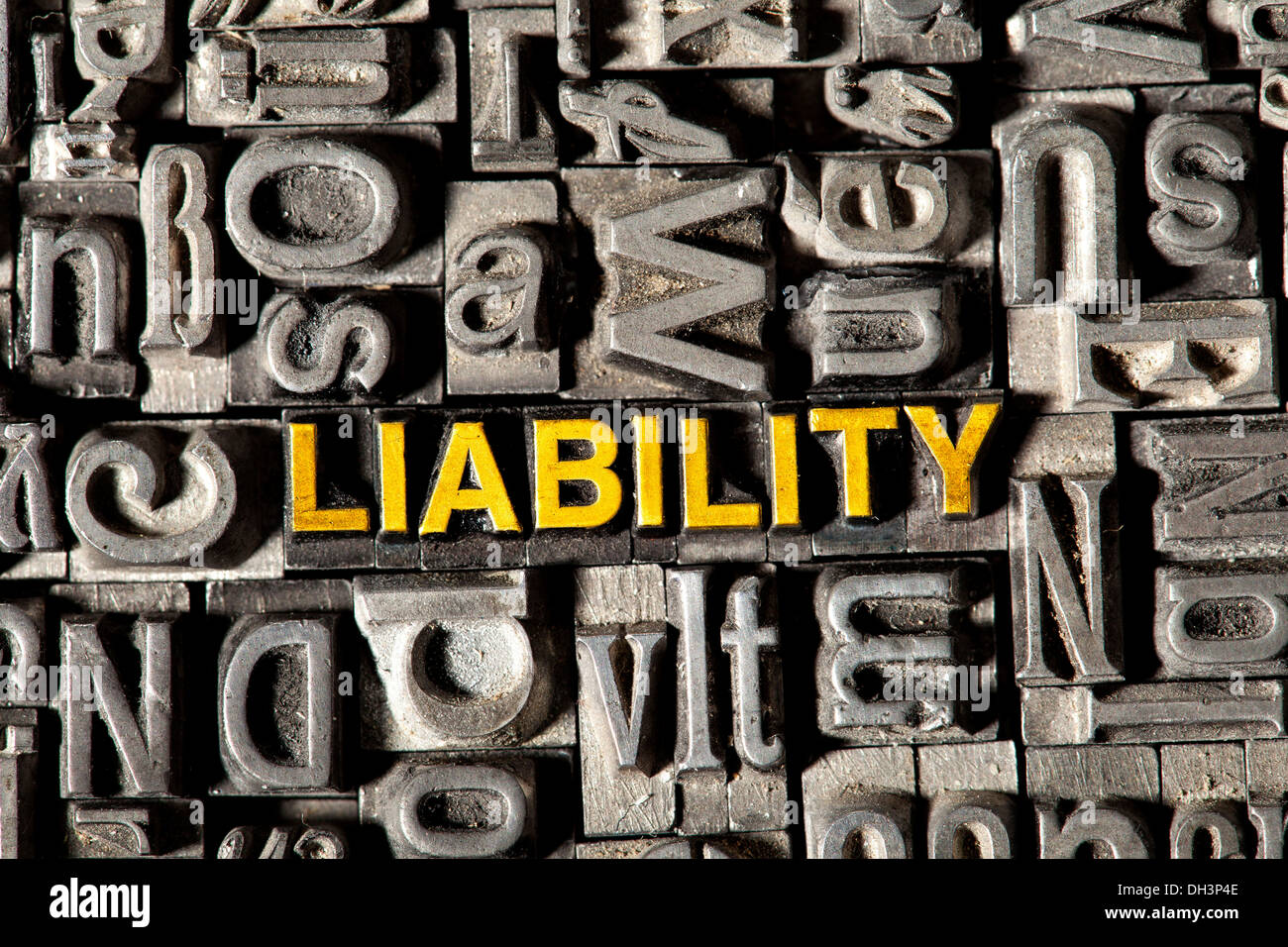 Old lead letters forming the word 'LIABILITY' Stock Photo