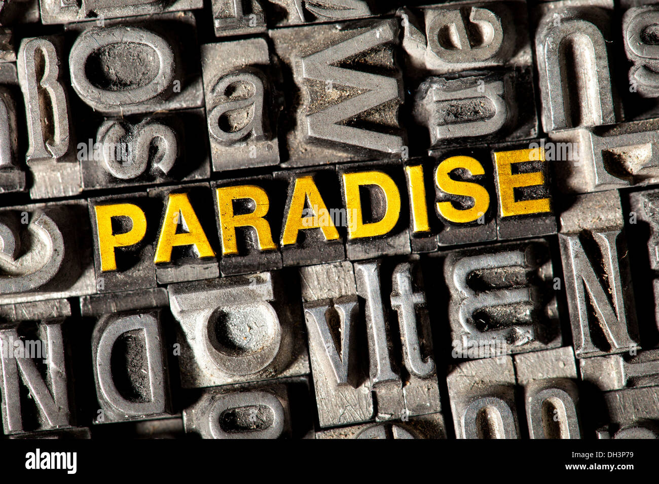 Old lead letters forming the word PARADISE Stock Photo