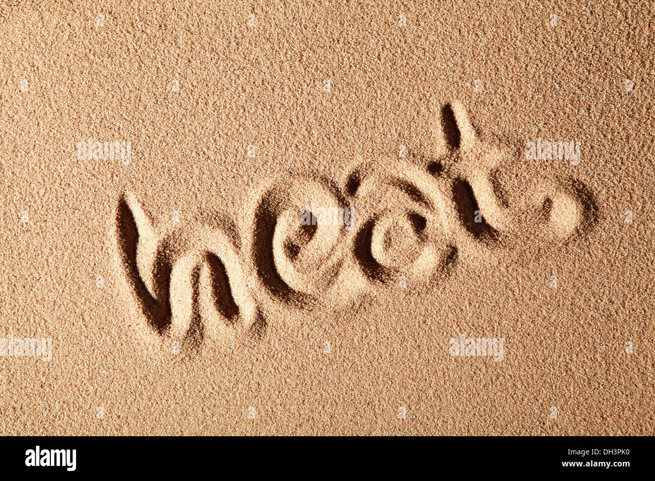 The word heat, written in sand Stock Photo
