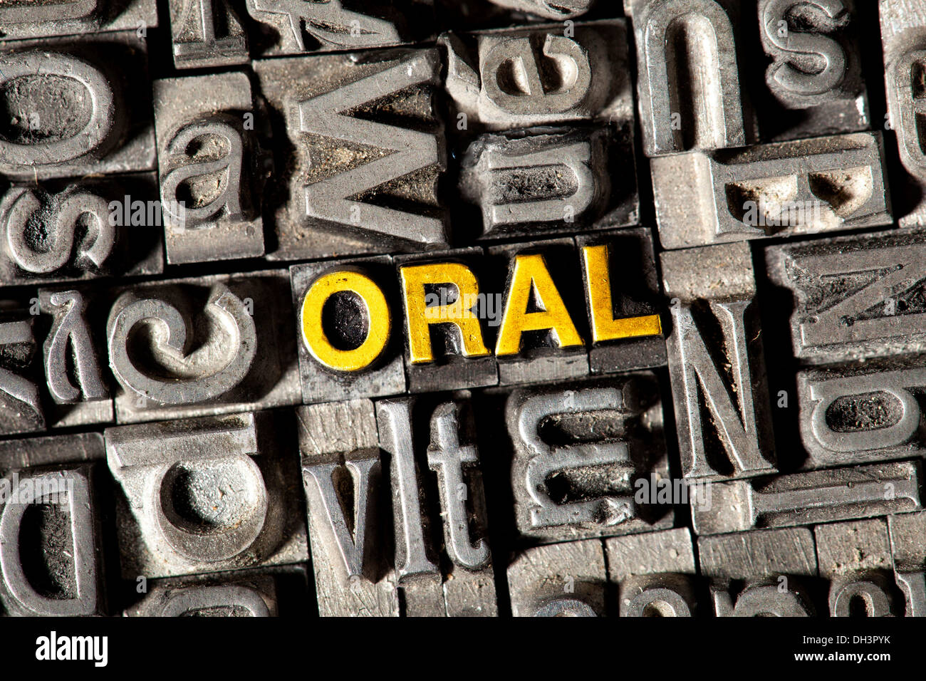 Old lead letters forming the word ORAL Stock Photo