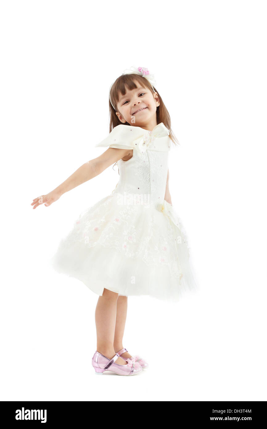 Smiling cute girl posing in white dress Stock Photo - Alamy