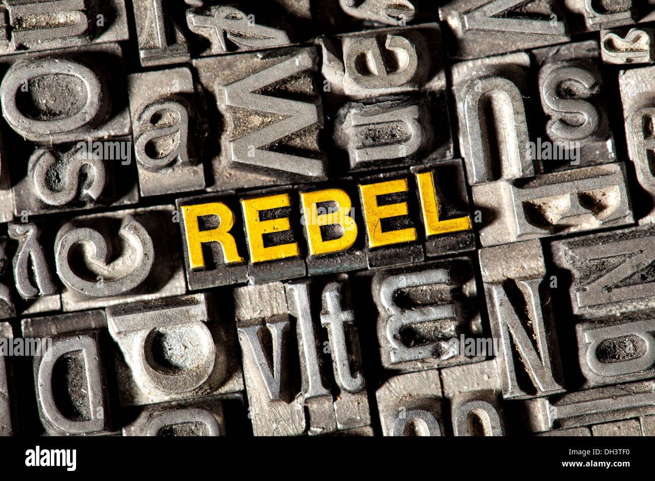 Old lead letters forming the word REBEL Stock Photo