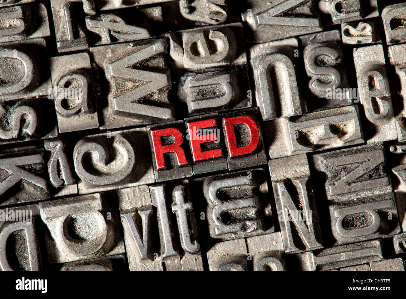 Old lead letters forming the word RED in red letters Stock Photo
