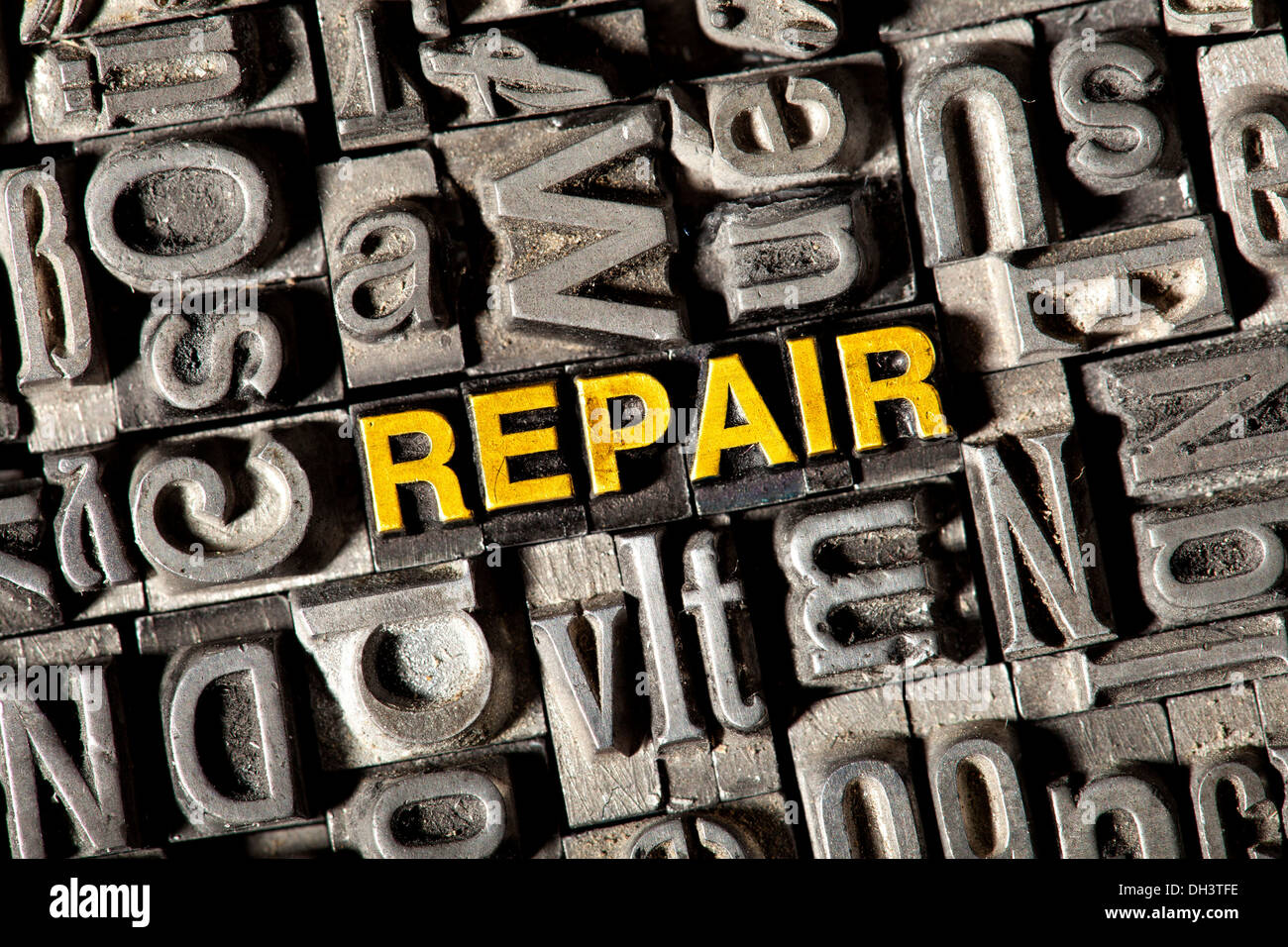 Old lead letters forming the word REPAIR Stock Photo