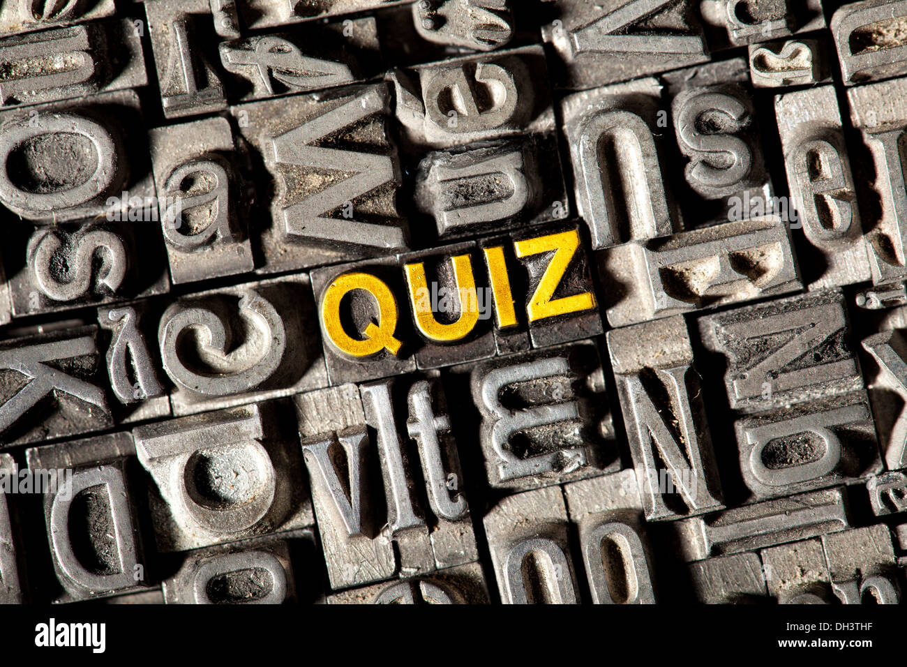 Old lead letters forming the word 'QUIZ' Stock Photo