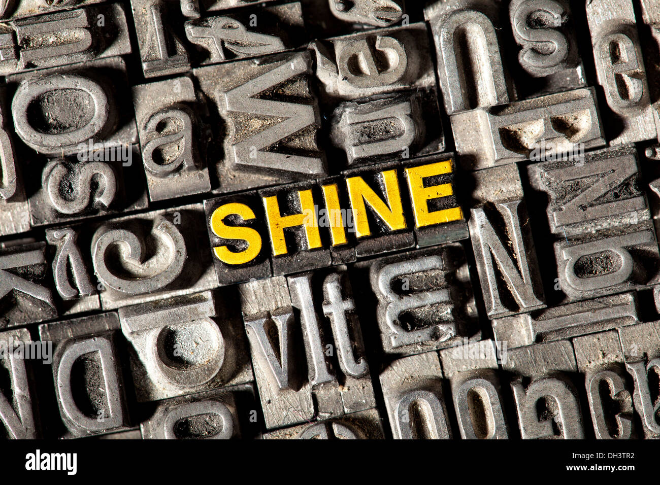 Old lead letters forming the word 'SHINE' Stock Photo