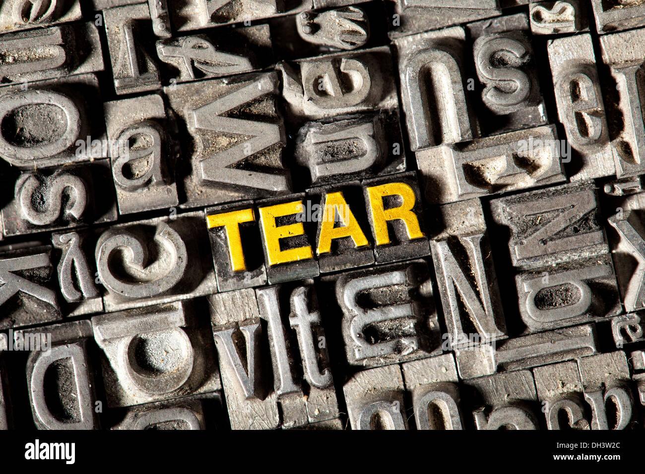Old lead letters forming the word 'TEAR' Stock Photo