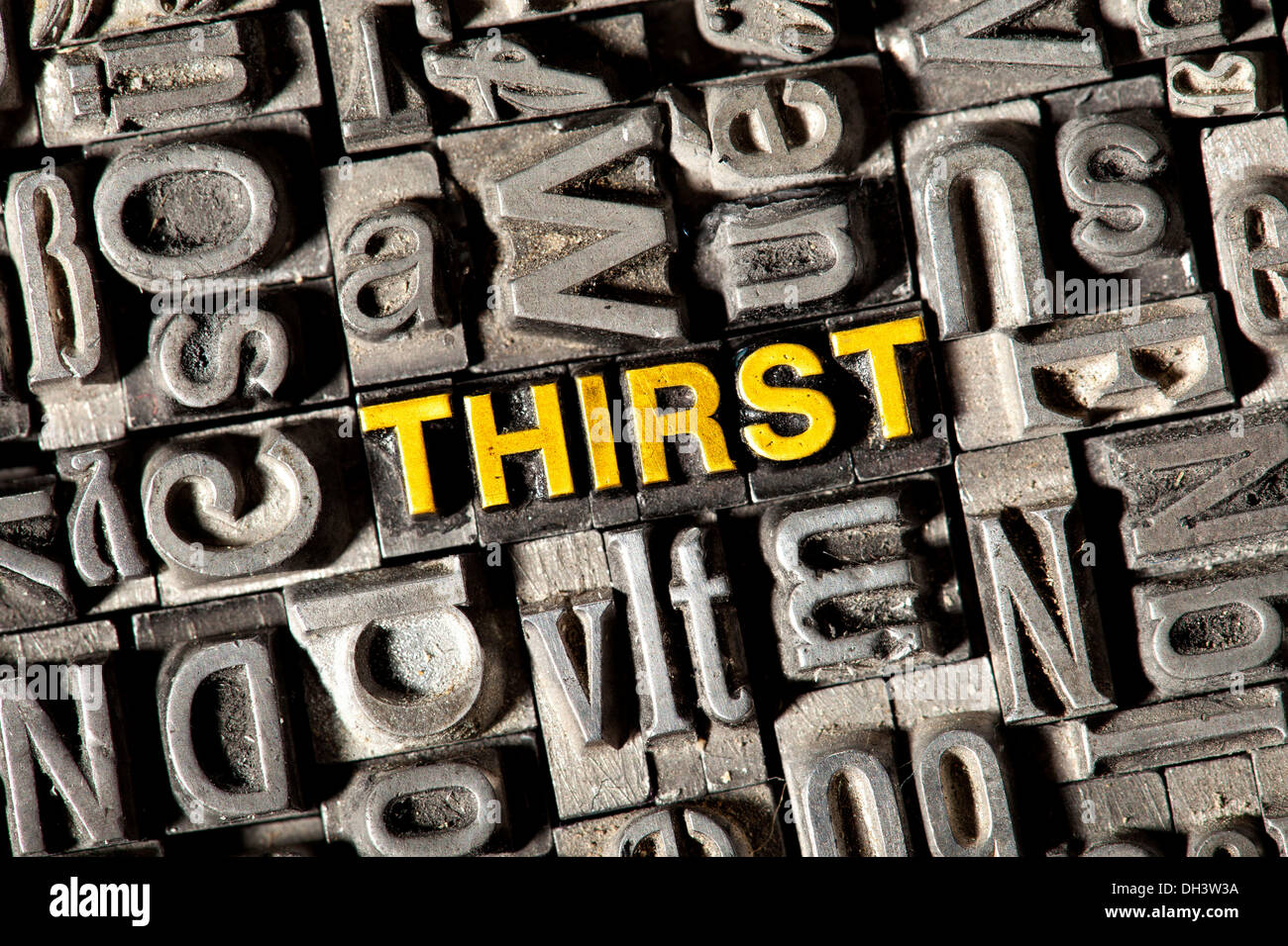 Old lead letters forming the word 'THIRST' Stock Photo