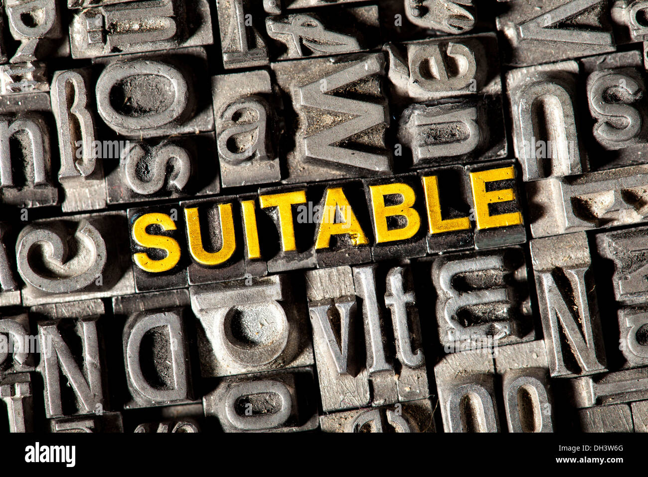 Old lead letters forming the word 'SUITABLE' Stock Photo