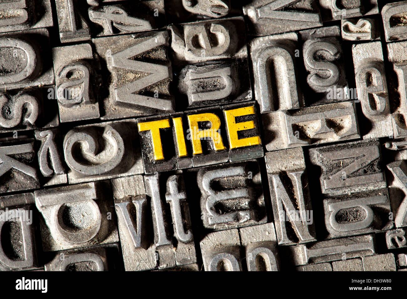 Old lead letters forming the word Tire Stock Photo