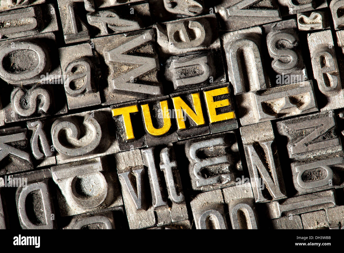 Old lead letters forming the word Tune Stock Photo