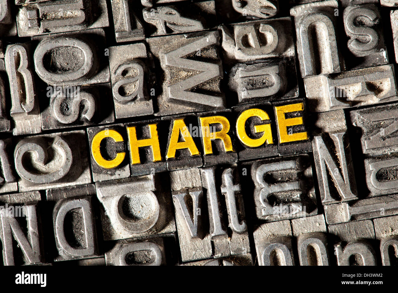 Old lead letters forming the word Charge Stock Photo