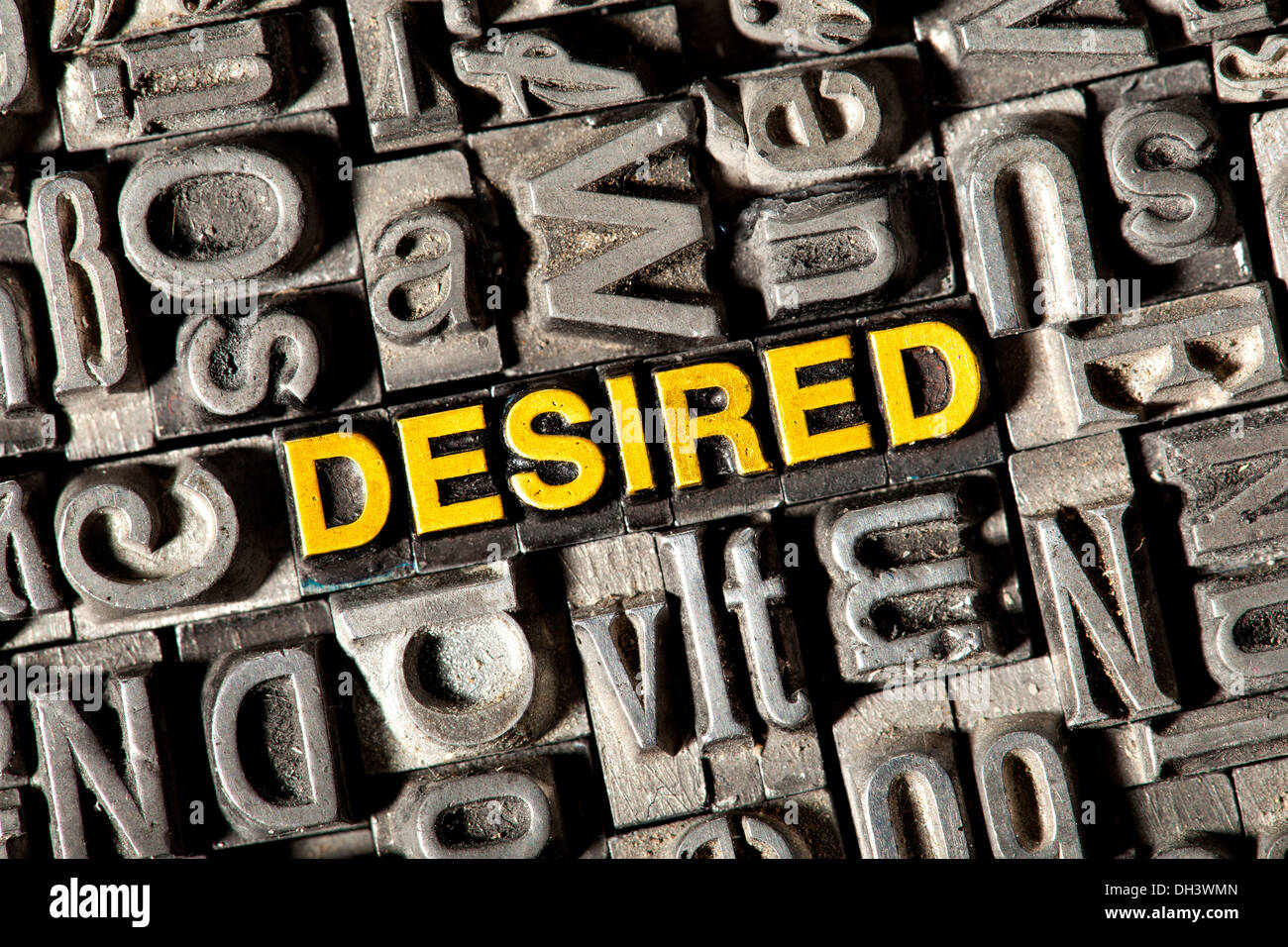 Old lead letters forming the word Desired Stock Photo