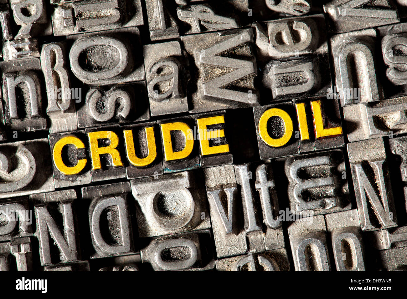 Old lead letters forming the words Crude Oil Stock Photo