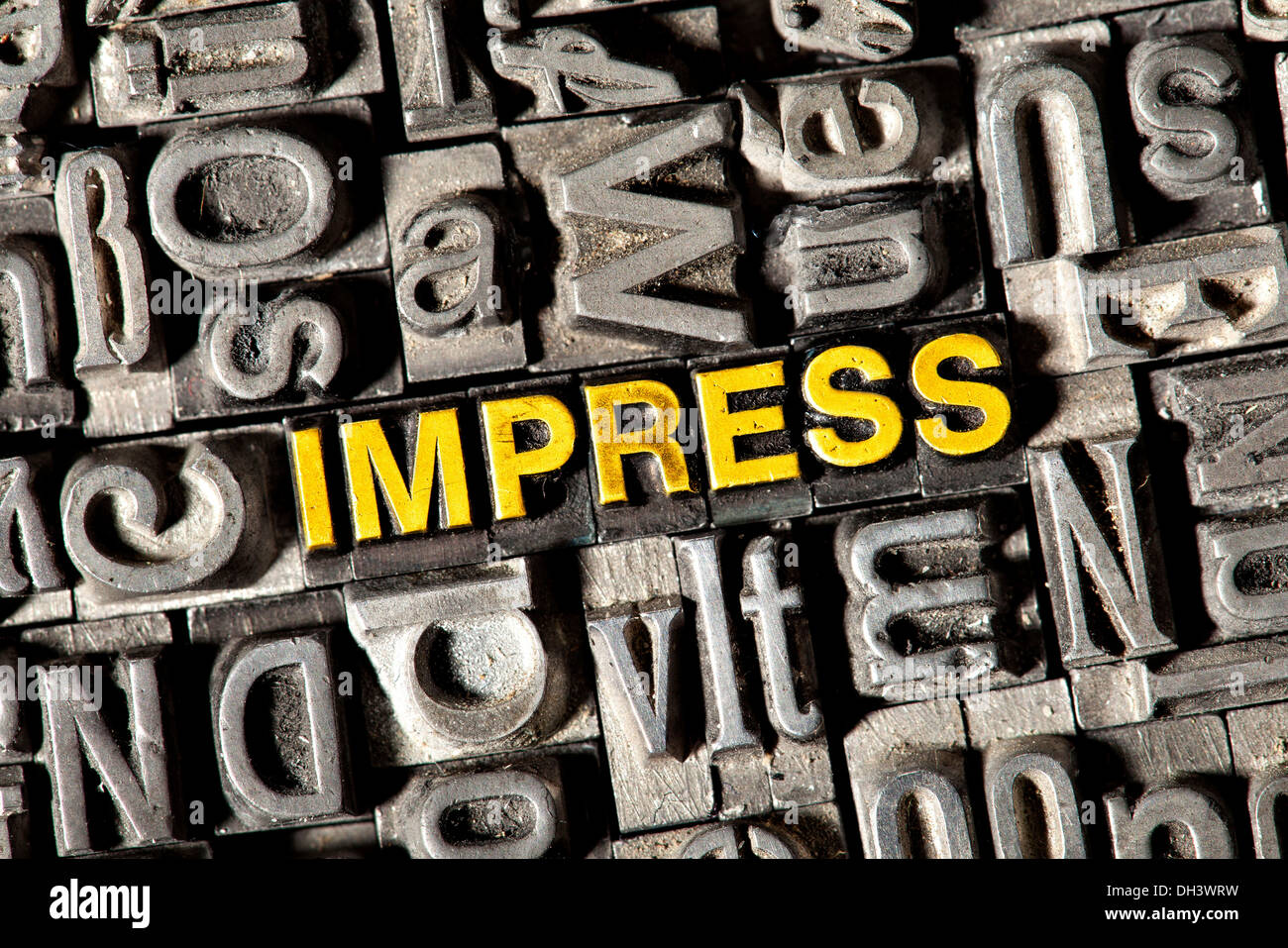 Old lead letters forming the word Impress Stock Photo