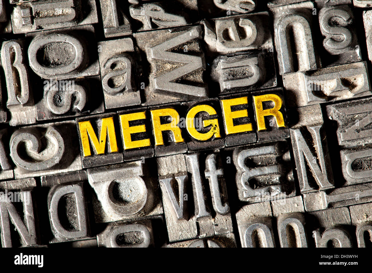 Old lead letters forming the word Merger Stock Photo