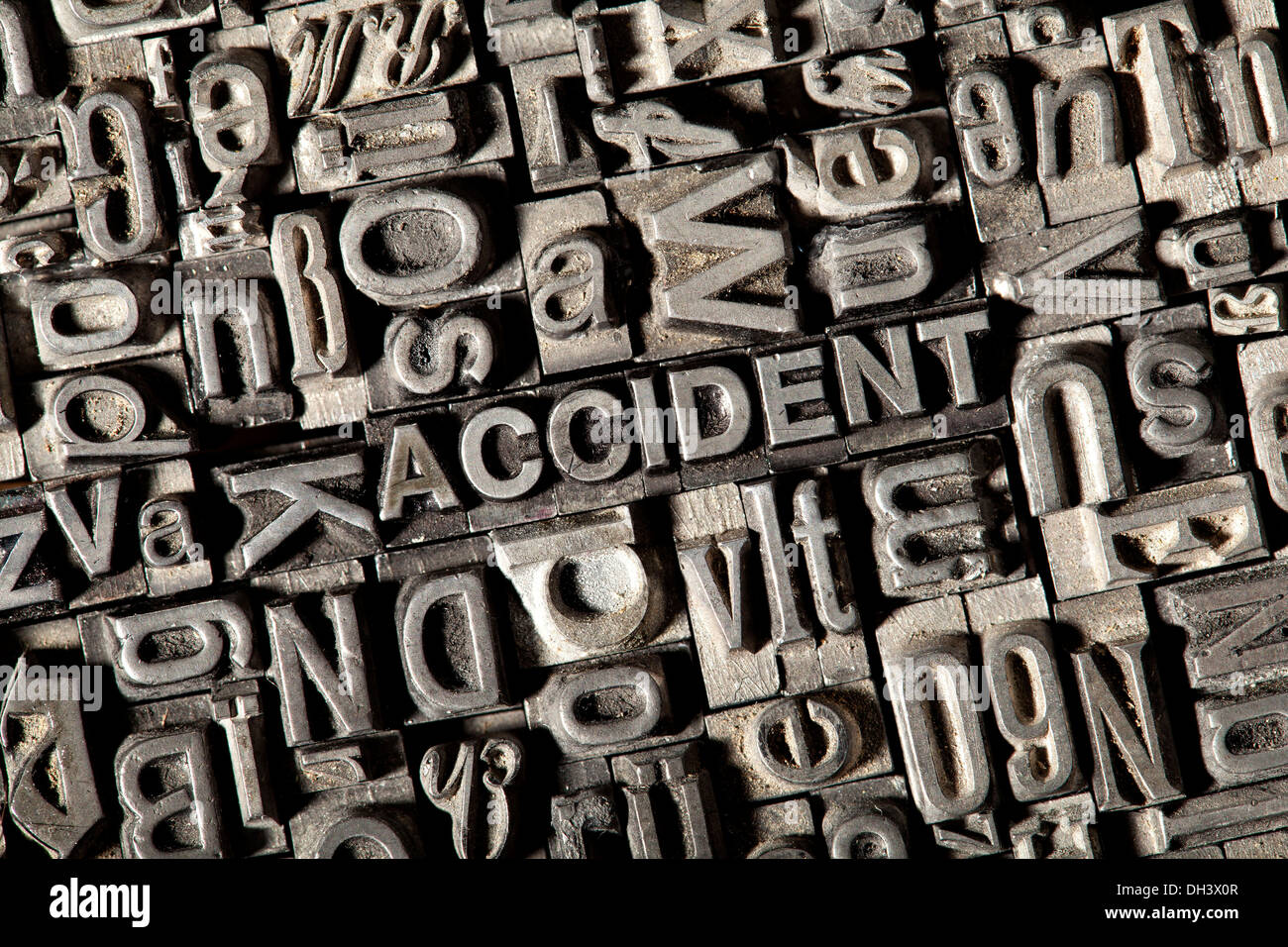 Old lead letters forming the word "ACCIDENT" Stock Photo