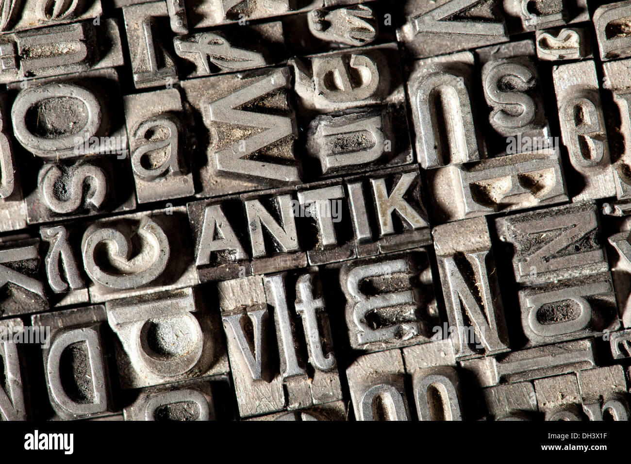 Old lead letters forming the word 'ANTIK', German for 'ANTIQUE' Stock Photo