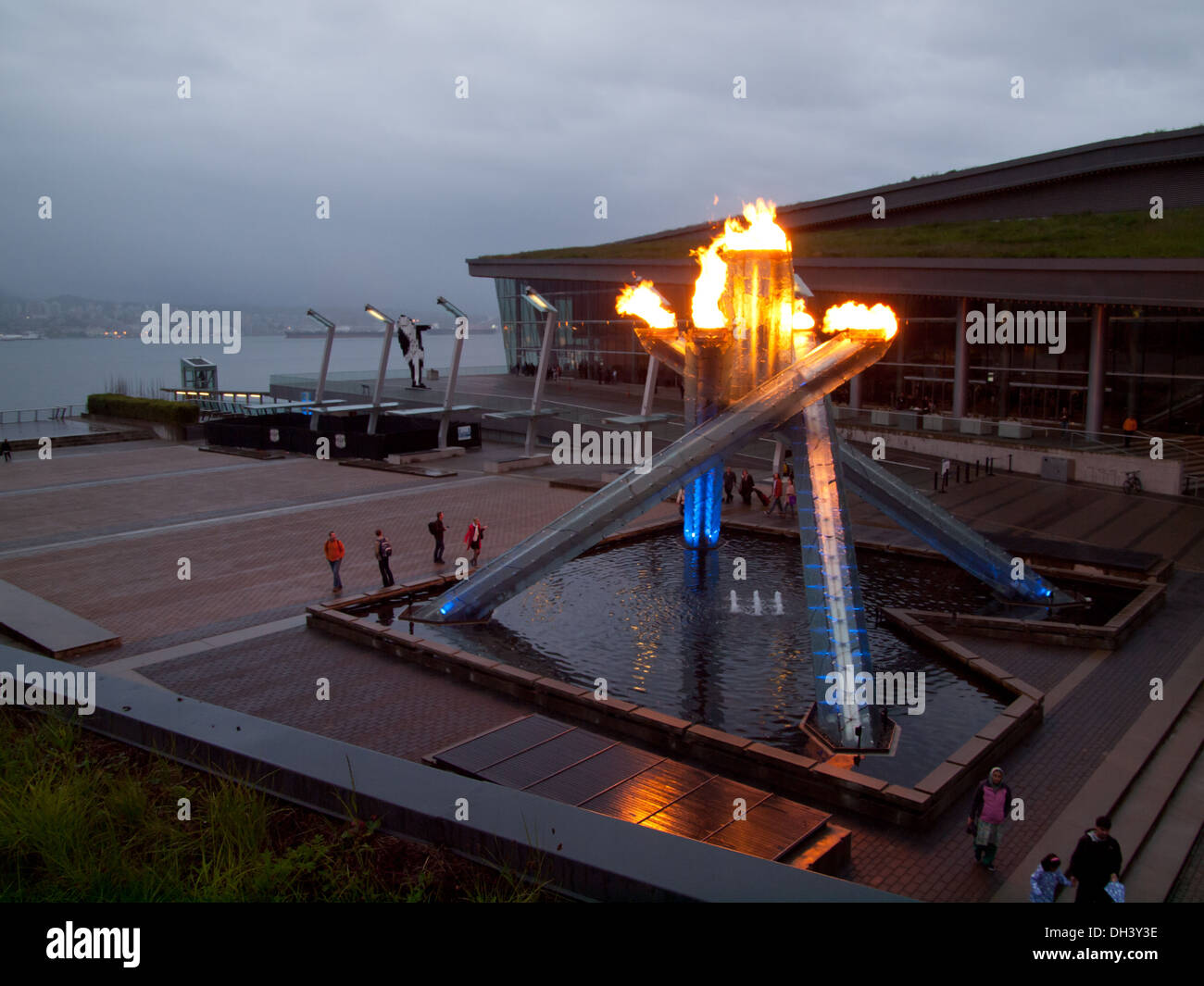 The Vancouver Olympic Cauldron is lit during the rain on Jack Poole Plaza at the Vancouver Convention Centre in Vancouver, BC. Stock Photo